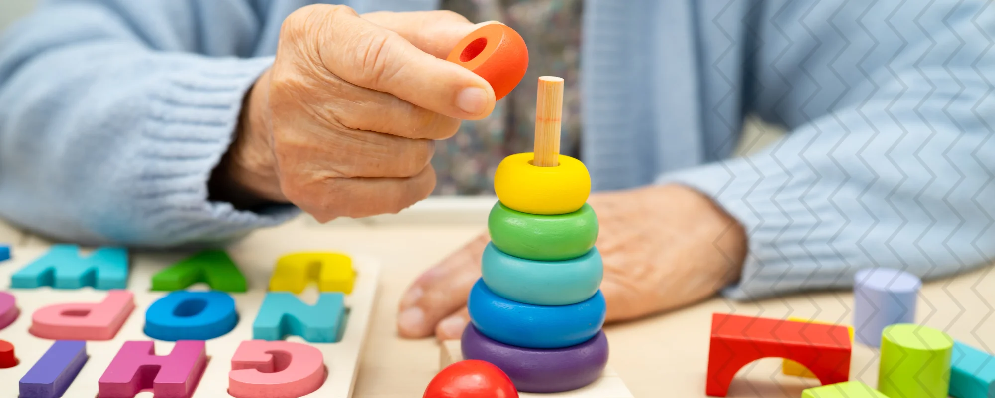 Persona mayor realizando actividad de estimulación cognitiva con materiales manipulativos; curso de Estimulación Cognitiva en Demencias de IEN